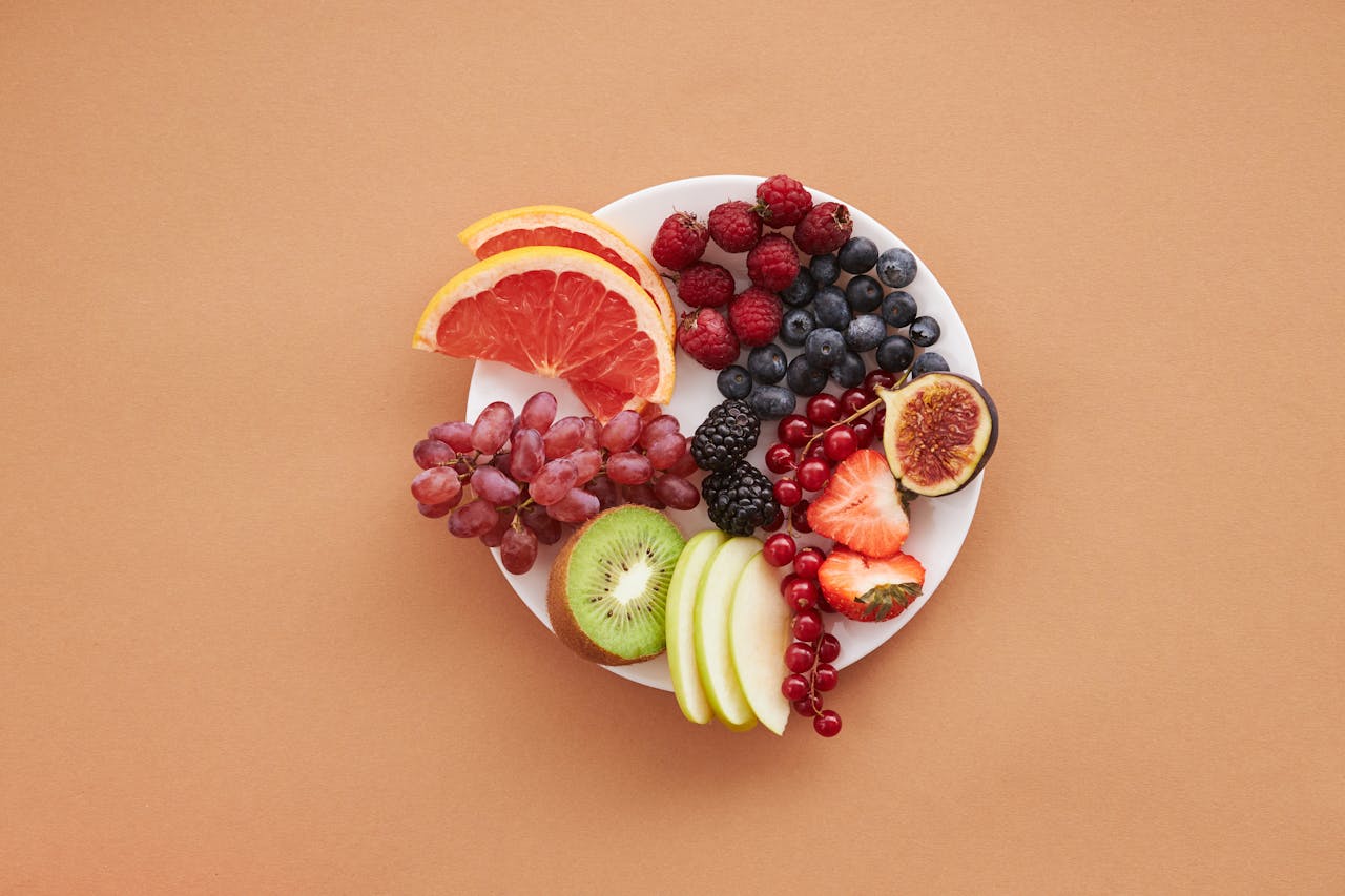 why-choose-us Colorful assortment of fresh fruits on a plate, perfect for healthy eating and vegan diet ideas.